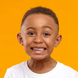 Boy smiling on orange background