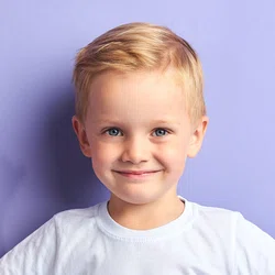 Boy smiling on purple background