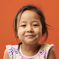 Girl smiling on orange background
